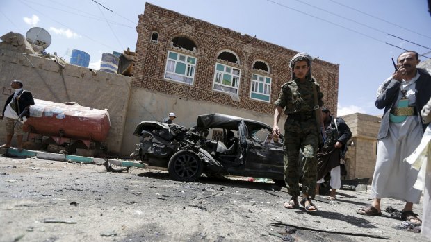 Houthi militants at the scene of a suicide bombing outside a mosque in Sanaa on Friday. 