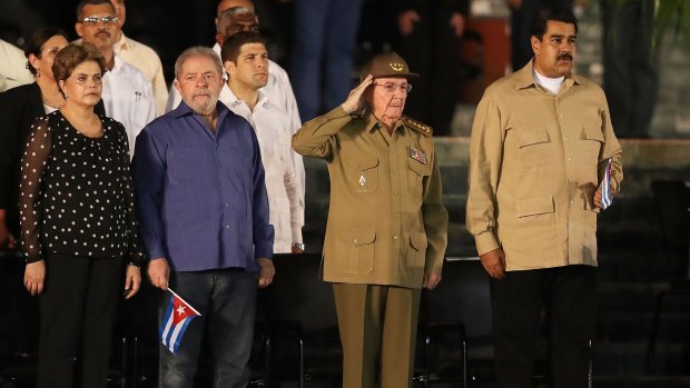 Raul Castro salutes, flanked by (left) former Brazilian presidents Luiz Inacio Lula da Silva and his recently impeached successor Dilma Rousseff and Venezuelan President Nicolas Maduro, right.