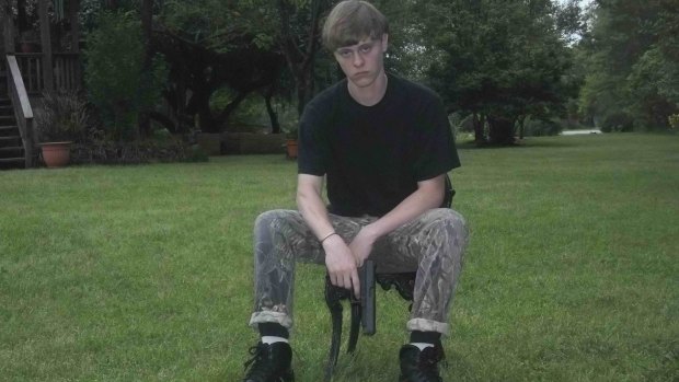 A handout photograph posted to a website with a racist manifesto appears to show Dylann Roof posing with a handgun. 