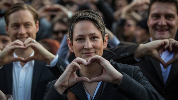 Christy Hackney-Westmore, centre, who was recently legally married in New Zealand, at the rally for a free vote on the marriage equality bill.