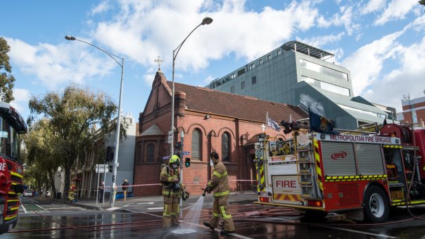 Firefighters clean up Victoria Parade.