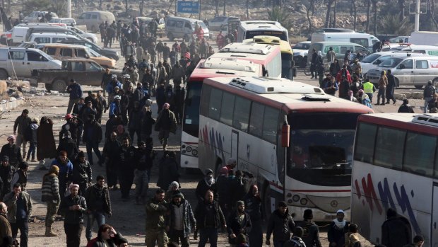 Syrians evacuated from Aleppo arrive in buses at a refugee camp in Rashidin, Syria. 