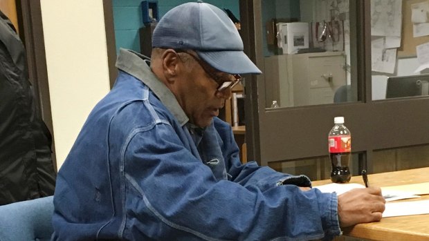 Released: OJ Simpson signs his release documents at the Lovelock Correctional Center in northern Nevada.