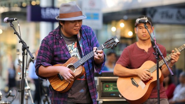 Aldrine Guerrero, with ukulele, and Aaron Nakamura from Ukulele Underground perform in the Queen Street Mall as part of the Spruke.