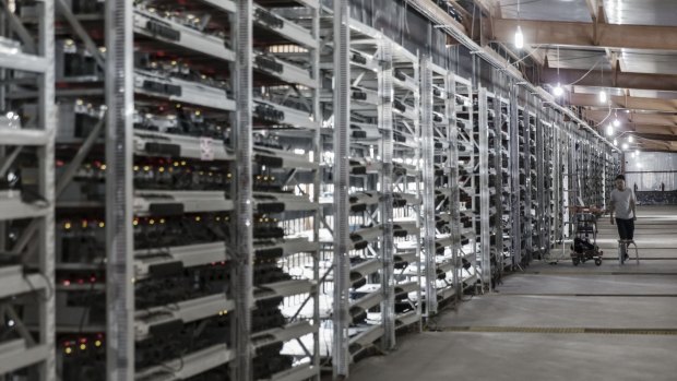 A technician inspects bitcoin mining machines at a facility operated by Bitmain Technologies in Inner Mongolia, China.