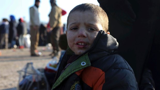 A young Syrian boy evacuated from Aleppo arrives at a refugee camp.