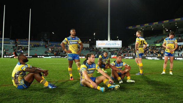 Shattered: Eels players contemplate their last-gasp defeat to South Sydney.