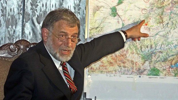 Ahmad Yusuf Nuristani points  to a map of Afghanistan's north-east after a 2002 earthquake.
