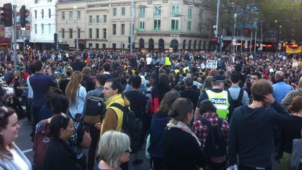 Protesters sat at the intersection of Flinders and Swanston Street.
