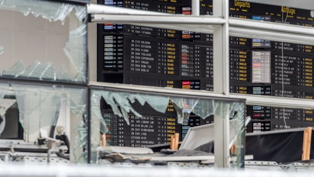 An arrivals and departure board and blown-out windows at Zaventem Airport in Brussels after a deadly bombing in March.