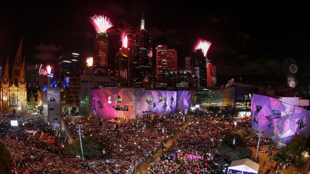 The midnight fireworks display, seen from Federation Square, lights up the city skyline during the New Year's Eve celebrations.