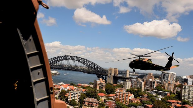 One of two Black Hawk helicopters from the Australian Army's 6th Aviation Regiment fly over Sydney Harbour during a training exercise. 