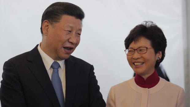 Chinese President Xi Jinping, left, speaks to Carrie Lam, Hong Kong's chief executive-elect, in West Kowloon.
