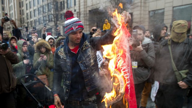 A protester burns a Donald Trump shirt during a demonstration in downtown Washington on January 20.