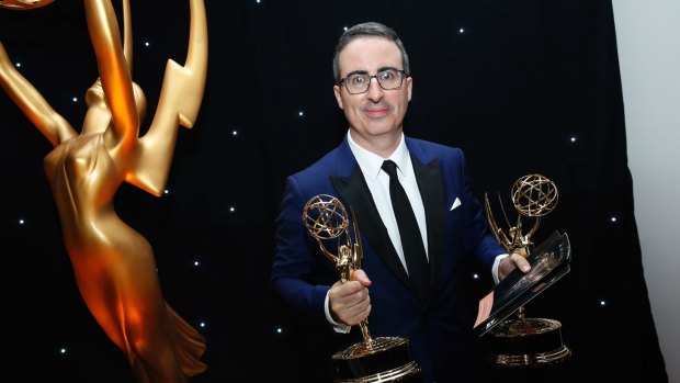 John Oliver poses with his awards for <i>Last Week Tonight With John Oliver</i> at the 69th Primetime Emmy Awards.