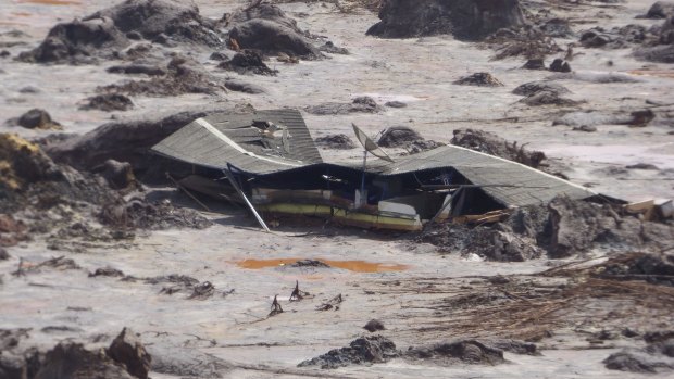 A farmhouse is buried in mud after the Samarco dam failure. BHP revealed that the death toll from the disaster had risen to 17, with two people still unaccounted for.