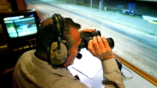 Special relationship: Race caller Paul Ambrosoli at the Bulli Greyhounds in August 2004.