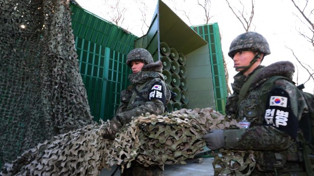 South Korean army soldiers remove camouflage from the loudspeakers near the border area between South Korea and North Korea in Yeoncheon, South Korea, on Friday.