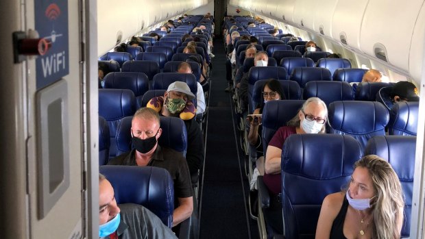 Masked passengers fill a Southwest Airlines flight in California.
