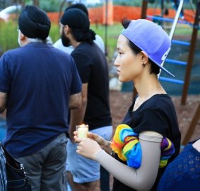 Residents and well-wishers pay their respects at a candelight vigil for Queenie Xu in a park across the road from where she was stabbed to death in Parkinson.