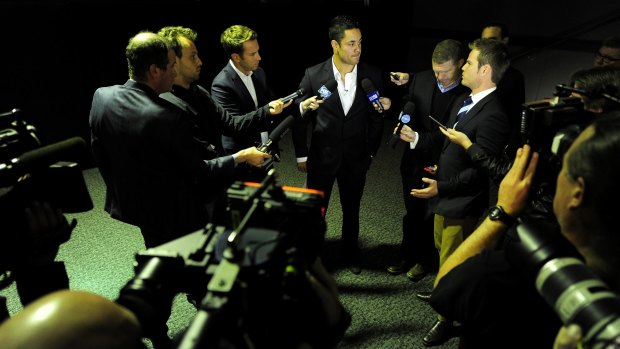 Swamped: Jarryd Hayne is surrounded by the media after making his announcement.