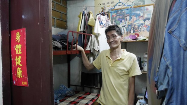 Hard to find work: Lam Ip-sang, in his sub-divided flat.