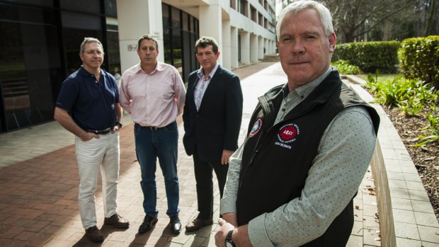 ACT ambulance service intensive care paramedics Jim Arneman, Justin Hockley and Steve Mitchell, with National Council of Ambulance Unions president Steve McGhie, are angry nothing has been done about reforms.