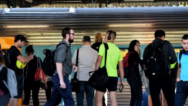 Commuters wait for trains at Strathfield Station on Monday morning.