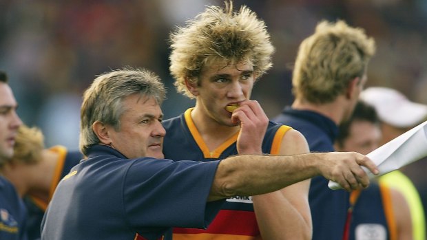 Adelaide coach Neil Craig instructs a younger Fergus Watts when he turned out for the Adelaide Crows in 2004.