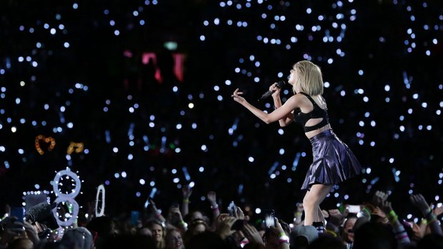 Ocean of blue light: Taylor Swift performs during her 1989 World Tour.