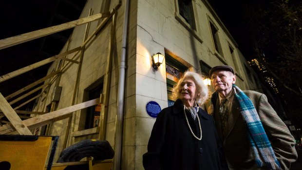 Lola Russell and George Dixon outside their 167-year-old home on the corner of King and La Trobe streets on Tuesday night. The building has been braced to stop its possible collapse. 