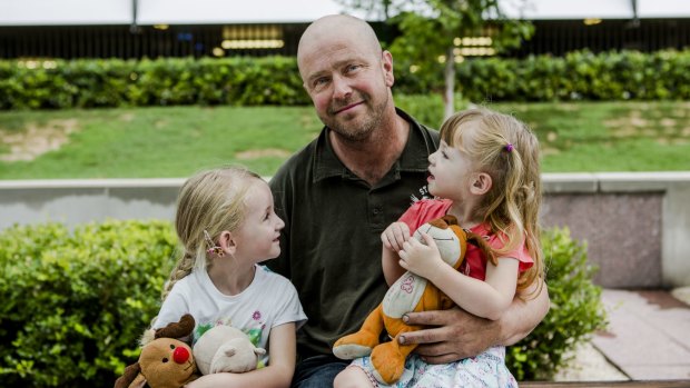 Returning ACT Remote Area Firefighter Terry Dwyer with his daughters Hannnah, 5 and Emily, 2. 
