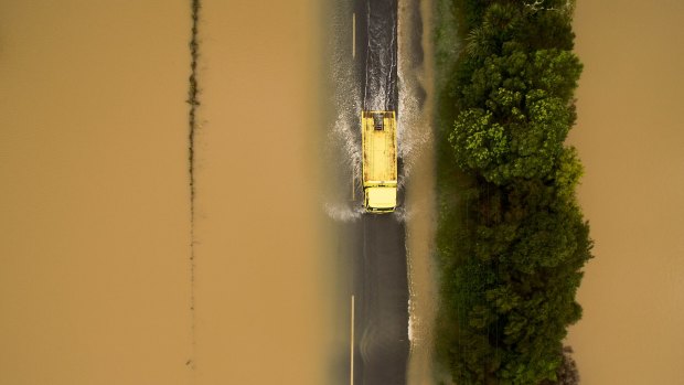 A yellow truck drives through flood waters after heavy rain caused flooding near Clevedon.