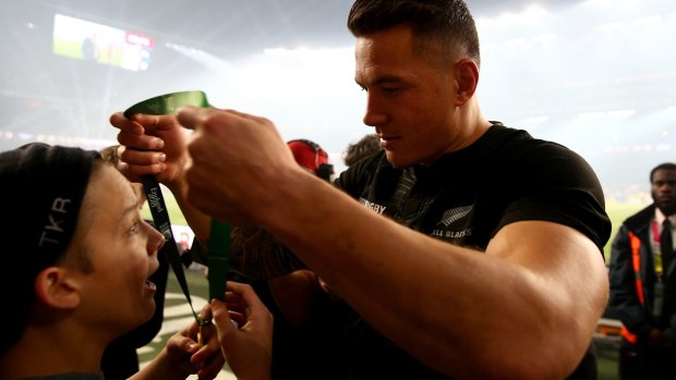 Touching gesture: Sonny Bill Williams hands his medal to young fan Charlie Line.