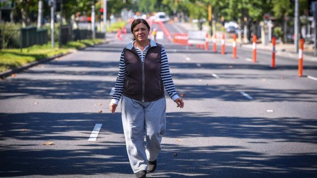 'I just feel better': Collingwood resident Nuray Benek takes a walk down a deserted Hoddle Street, normally teeming with traffic. 