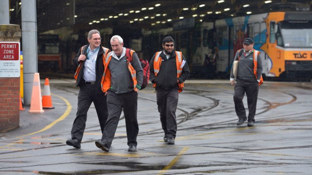 Tram workers walk out on strike after dropping the tram at the Camberwell depot. 