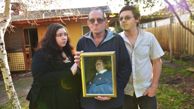 John Moller holds a photo of his wife Jennifer Moller who was killed by a hit a run in 2012. John is pictured with his daughter Jemma and son PJ. 