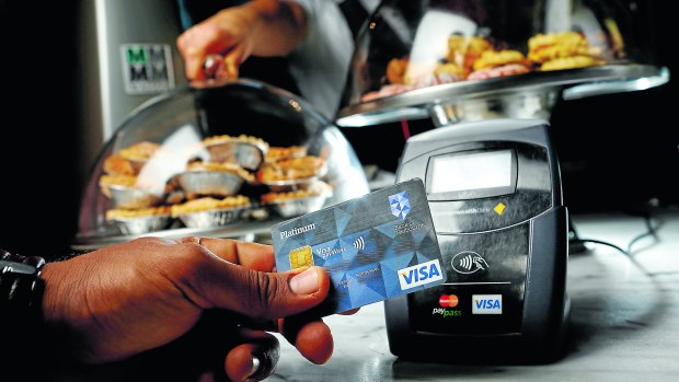 A customer pays by Visa payWave. Contactless payment systems have become popular in an increasingly cashless society. 