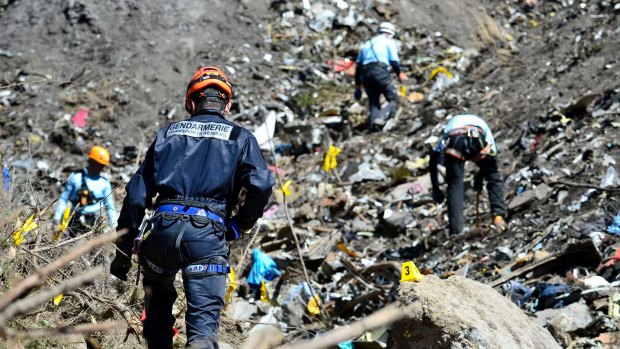 French emergency rescue services work at the crash site.