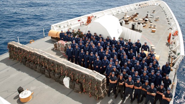 Staff on the Coast Guard Cutter Stratton pose for a photo with cocaine bales seized from a self-propelled semi-submersible in international waters off the coast of Central America last month.