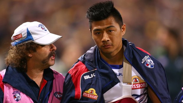 Bulldogs doctor Gary Zimmerman with Lin Jong after Jong injured his collarbone in the elimination final earlier this year.