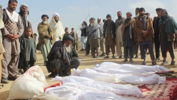 Afghan villagers gather around the bodies of people killed during clashes between Taliban and Afghan security forces in November 2016. Hekmatyar called for an end to the "pointless" war.