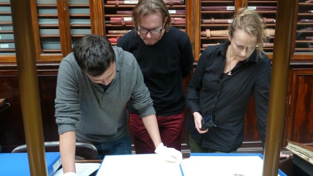 The artists view old master prints in the Museum of Archaeology and Anthropology as part of the Antipodes project.