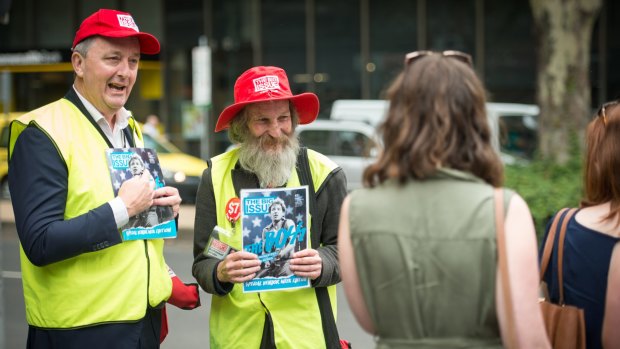 Minister for Housing Martin Foley with Big Issue vendor Russell (right) sells the latest issue to mark the beginning of International Vendors week. 