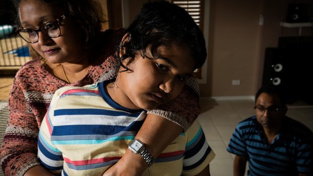 Dr Biswajit Banik and his wife Dr Sarmin Sayeed with their autistic son Arkojeet Banik.