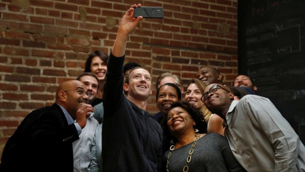 Facebook CEO Mark Zuckerberg takes a selfie with entrepreneurs and innovators after taking part in a roundtable discussion at Cortex Innovation Community technology hub in St Louis.