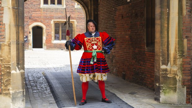 An actor portrays a guard at Hampton Court Palace, the former seat of Henry the VIII.