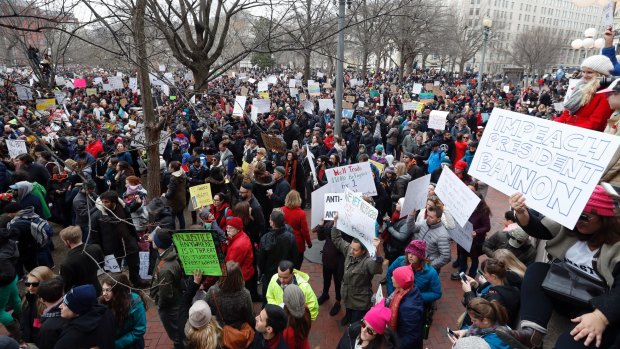 Protesters carry signs and chant in Lafayette Park near the White House during a demonstration to denounce President Donald Trump's executive order that bars citizens of seven predominantly Muslim-majority countries from entering the US.