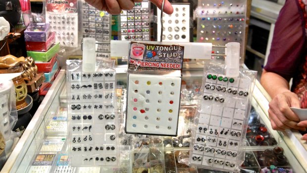 A stall at Paddy's Markets selling tongue studs.