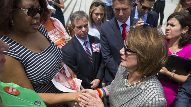 Nardyne Jefferies (left), of Washington, holds a photo of her 16-year-old daughter Brishell, who was murdered with a gun, as she talks to House Minority Leader Representative Nancy Pelosi. 